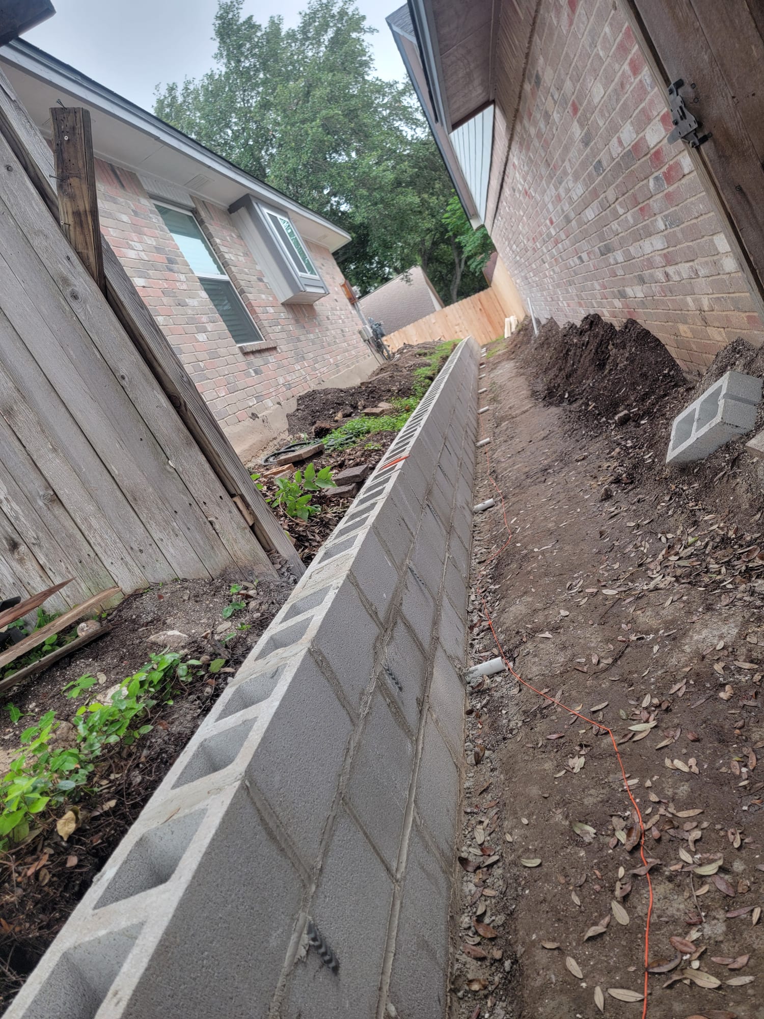 Concrete retaining wall construction between two homes